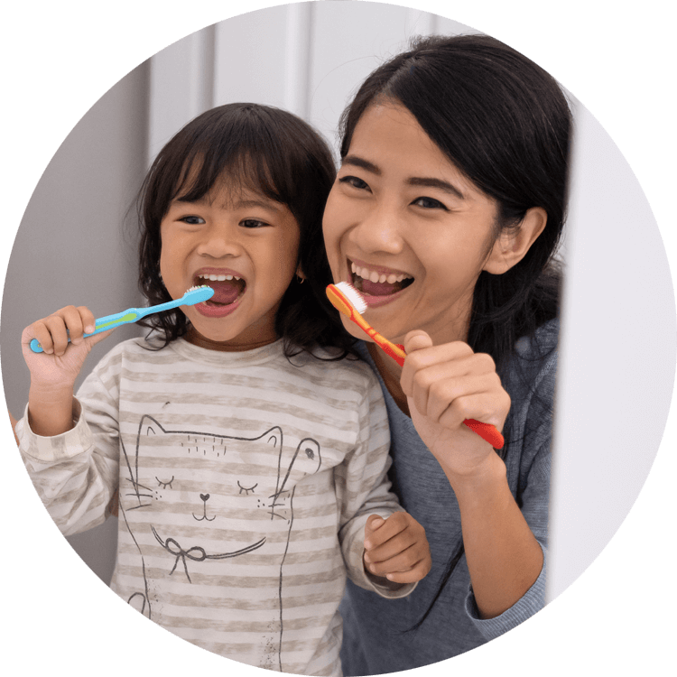 mother and daughter brushing teeth