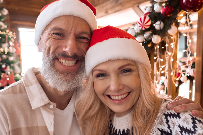 Dental Implant Patients Smiling During A Holiday Party