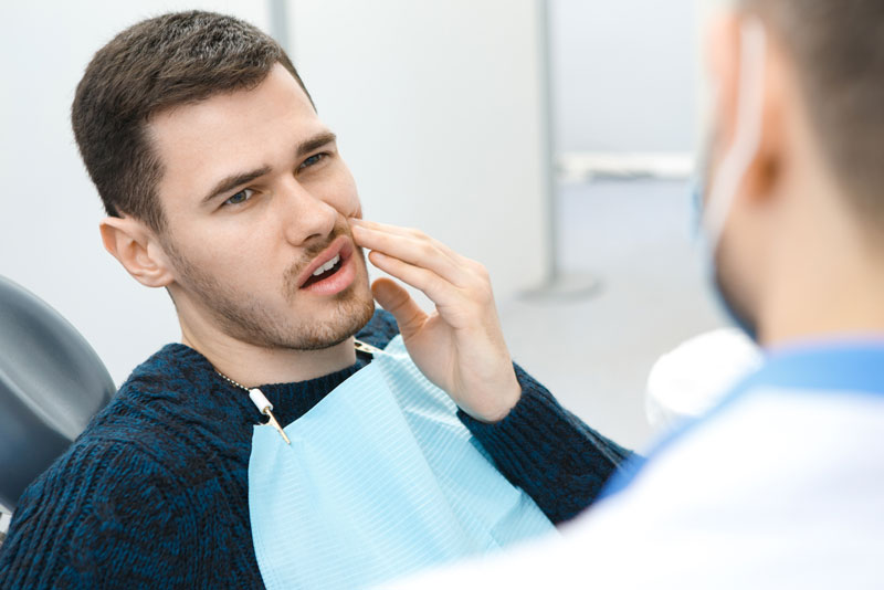 Dental Patient Suffering From Mouth Pain On A Dental Chair, In Charlotte, NC