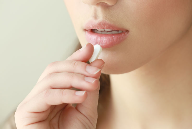 a dental patient taking a sedation pill