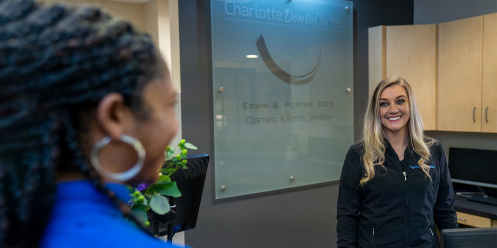 charlotte dental arts office coordinator with implant patient