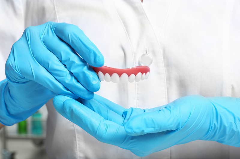 Photo of a doctor holding a pair of implants