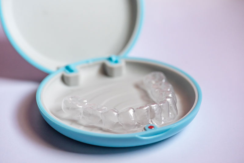 an invisalign clear aligner with a case to hold it in