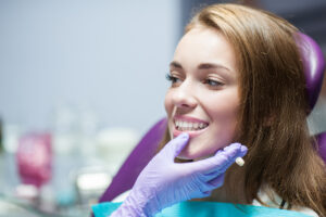 Dentist curing a woman patient in the dental office in a pleasant environment