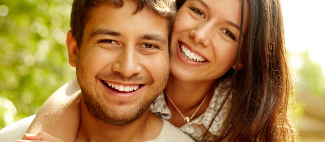Dental Patients Smiling With Well Cared For Dental Implants In Charlotte, NC