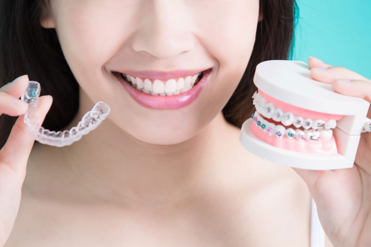 Dental Patient Holding Up Invisalign Retainers